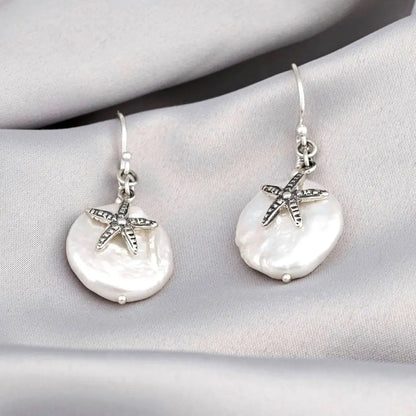 Parelmoer oorbellen met zeester - 925 sterling zilver