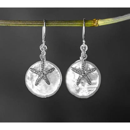 Parelmoer oorbellen met zeester - 925 sterling zilver
