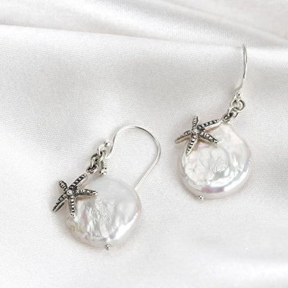 Parelmoer oorbellen met zeester - 925 sterling zilver