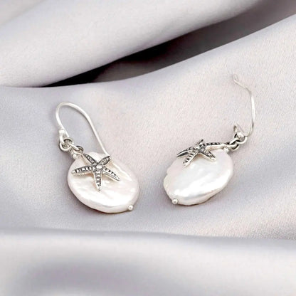 Parelmoer oorbellen met zeester - 925 sterling zilver